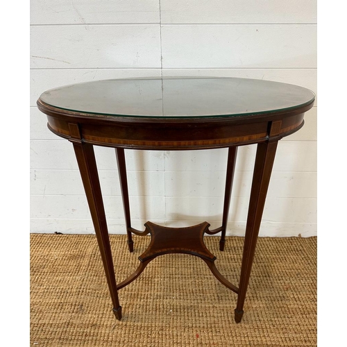 27 - An oval mahogany inlaid occasional table with central stretcher (H80cm W67cm D46cm)