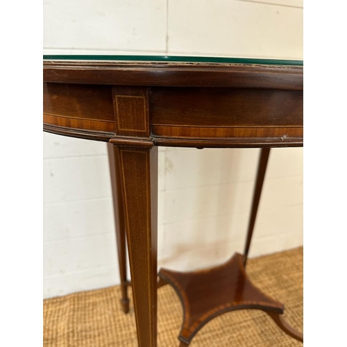 27 - An oval mahogany inlaid occasional table with central stretcher (H80cm W67cm D46cm)