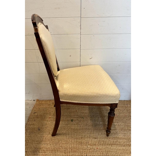 29 - Six Edwardian shield back and inlaid hall chairs upholstered in white