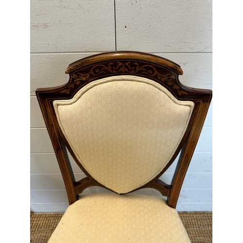 29 - Six Edwardian shield back and inlaid hall chairs upholstered in white