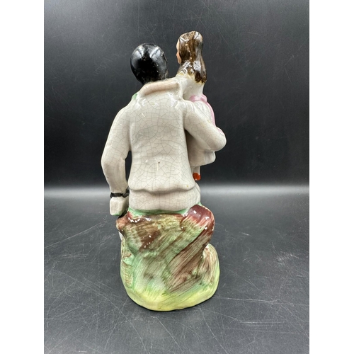 293 - A Staffordshire figure of Uncle Tom and Little Eva