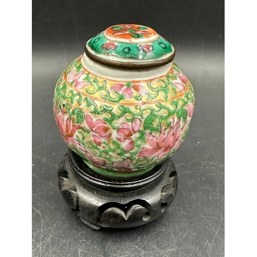 296 - Three Chinese style ceramic items, two lidded jars and a stem dish in the famille rose palette