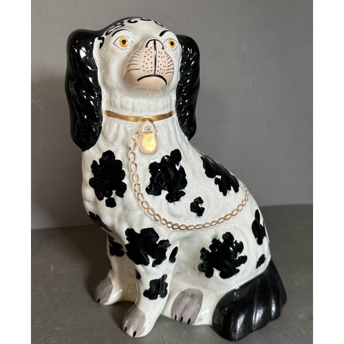 303 - A pair of Staffordshire black and white spaniels