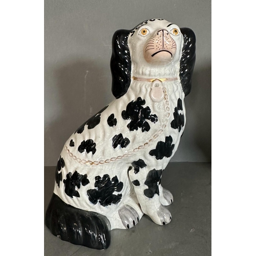 303 - A pair of Staffordshire black and white spaniels