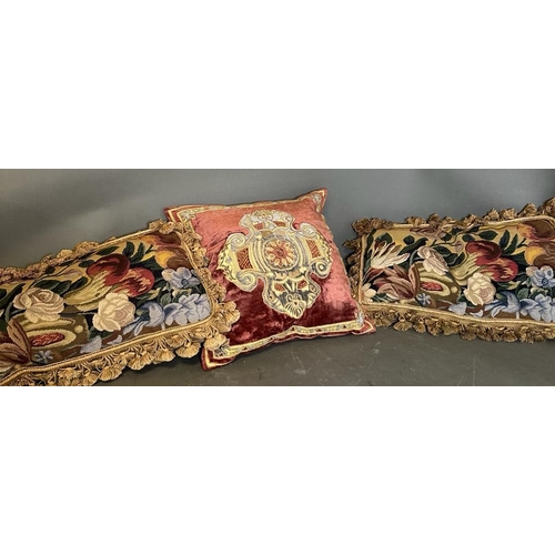 31 - Three vintage cushions, one velvet with central shield and two floral tapestry with tassels