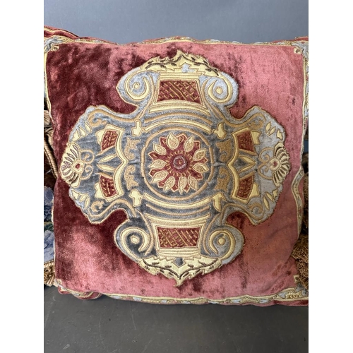 31 - Three vintage cushions, one velvet with central shield and two floral tapestry with tassels