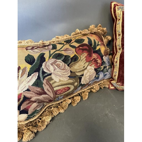 31 - Three vintage cushions, one velvet with central shield and two floral tapestry with tassels