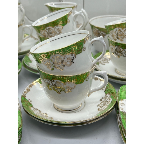 311 - A part tea set of green and gilt pattern by Lawleys