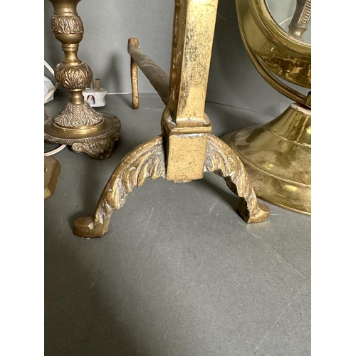 326 - A quantity of brass items to include candlestick, fire dogs and a mirror