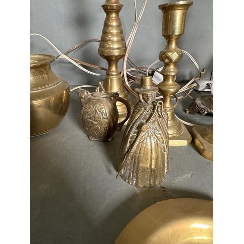 326 - A quantity of brass items to include candlestick, fire dogs and a mirror