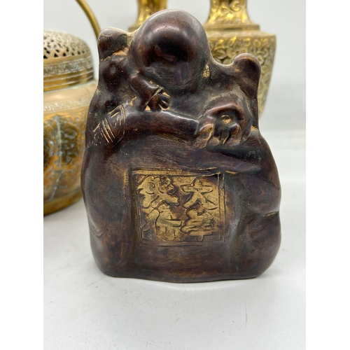 329 - A collection of brass including a laughing buddha and hand warmer/censer