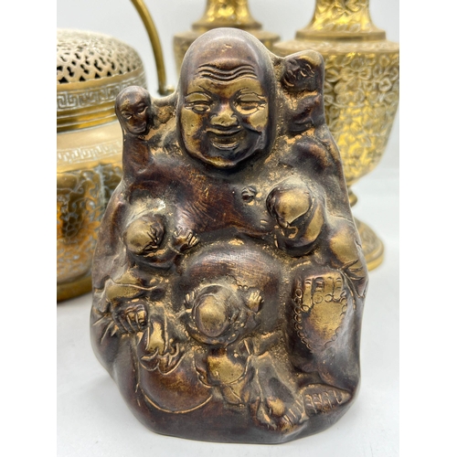 329 - A collection of brass including a laughing buddha and hand warmer/censer