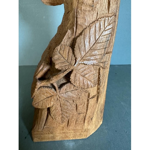 334 - A carved wooden statue of a sleeping owl perched on a branch (H61cm)