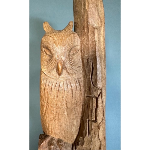 334 - A carved wooden statue of a sleeping owl perched on a branch (H61cm)