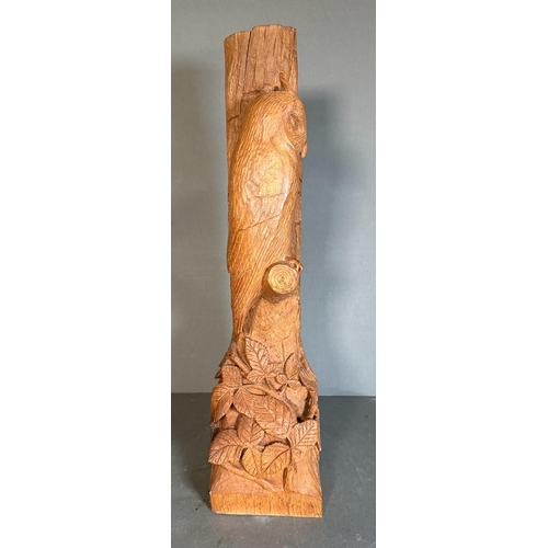 334 - A carved wooden statue of a sleeping owl perched on a branch (H61cm)