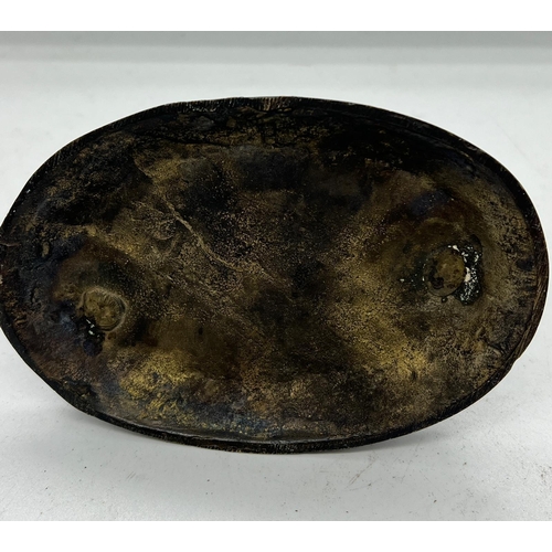 338 - A metal sculpture of a horse on an oval base (H13cm W16cm)