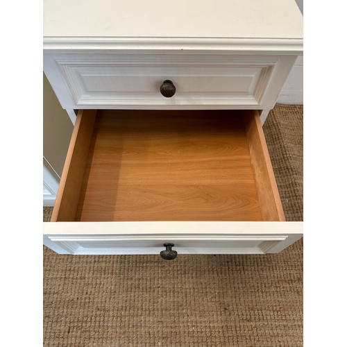 34 - A pair of white painted three drawer bedside tables