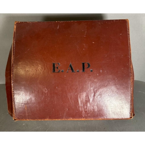 343 - A set of four vintage lawn bowl balls in a brown leather case, monogrammed E.A.P