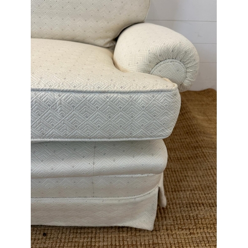 35 - A white upholstered three seater sofa