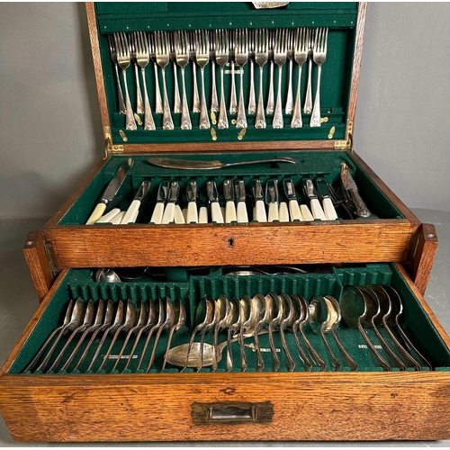 355 - A substantial oak canteen of cutlery with green interior and twelve place settings a Harlequin set.