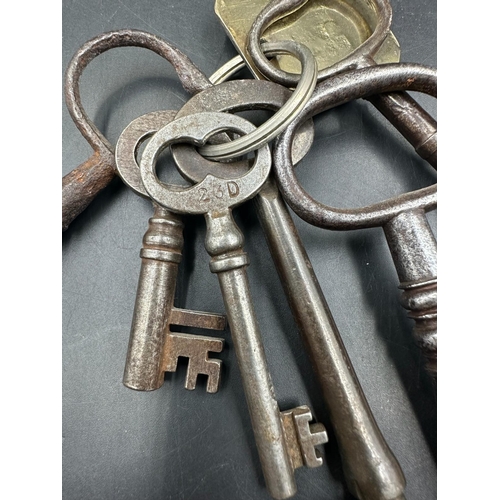 357 - A set of antique keys , most on a key ring with a brass tag marked 4038 DUPE