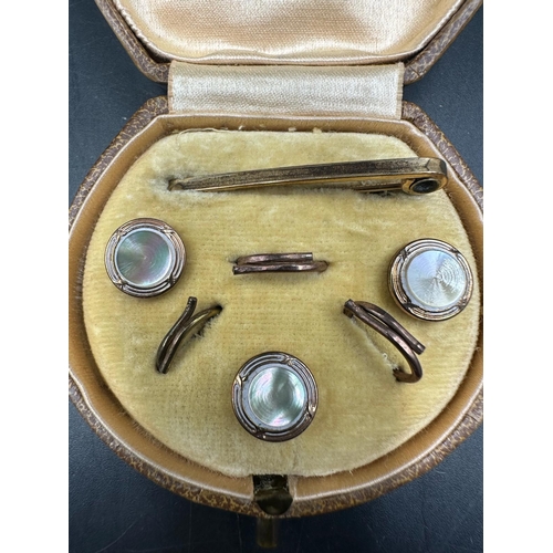 359 - A small leather cased box with gold metal Gents shirt studs/buttons set.