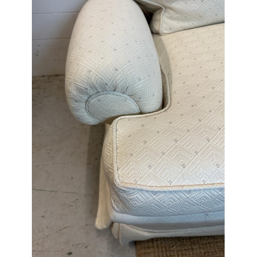 36 - A white upholstered three seater sofa