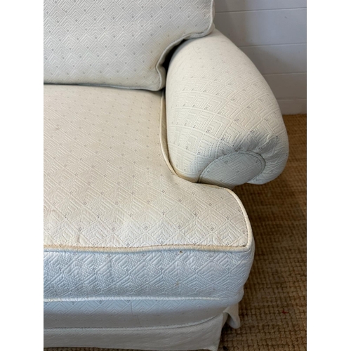 36 - A white upholstered three seater sofa