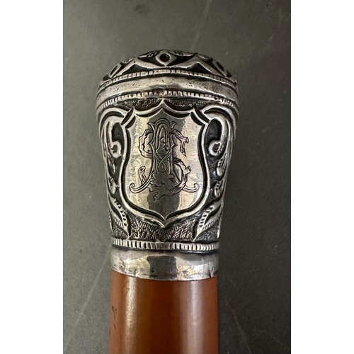 363 - A white metal topped walking cane with a floral pattern