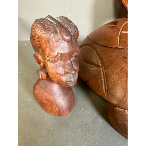 364 - A selection of tribal treen items to include busts, a mask and a decorative axe