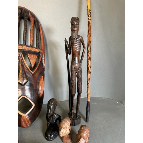 364 - A selection of tribal treen items to include busts, a mask and a decorative axe