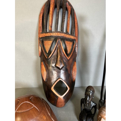 364 - A selection of tribal treen items to include busts, a mask and a decorative axe