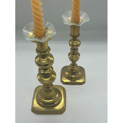 373 - A pair of brass candlesticks with glass finials