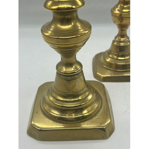 373 - A pair of brass candlesticks with glass finials