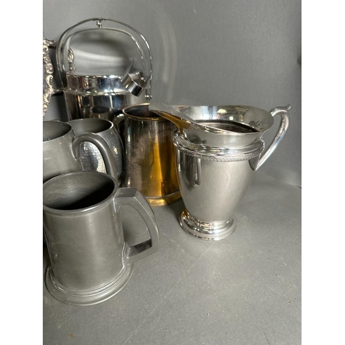 383 - A selection of silver plate, pewter and white metal items to include tankards, tray and a candle sti... 