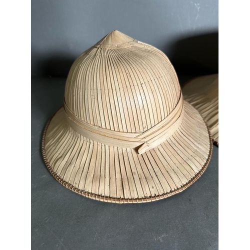 388 - A selection of reed hats and woven mats