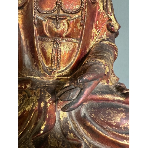 399 - A carved Buddha on carved stand in red and gilt, some damage but additional pieces present for resto... 