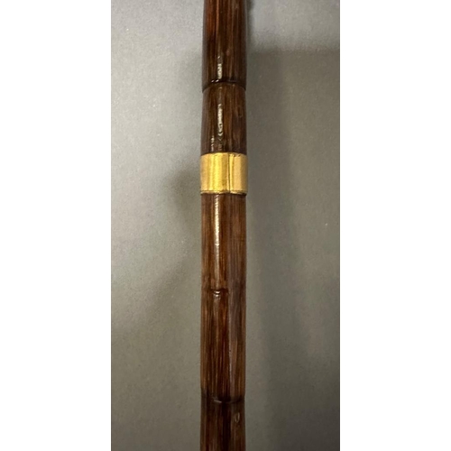 407 - A vintage bamboo walking cane with 18ct rolled hold handle tip