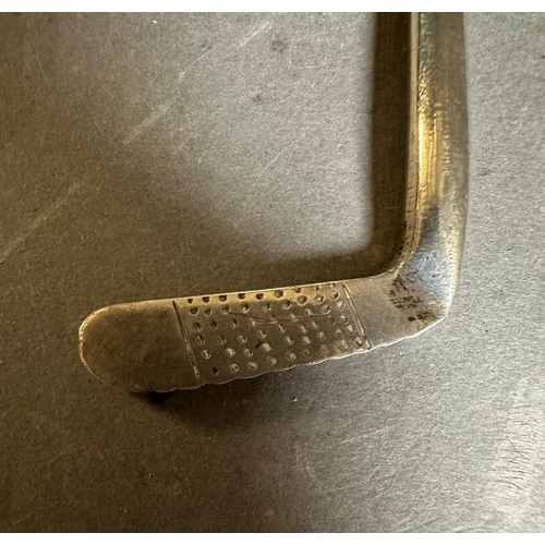 434 - An engraved golf trophy in the form of a putter on an ebonised based. The putter is silver and hallm... 