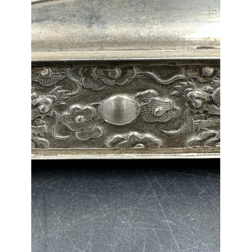 443 - A Chinese silver hairpin or hat pin box decorated with dragons and on four small feet, makers mark t... 