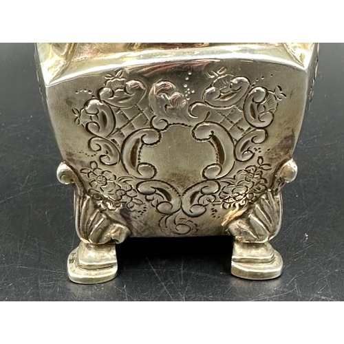 452 - An ornate, foliate decorated, sugar shaker on four hoof feet with obscure hallmarks. Approximate tot... 