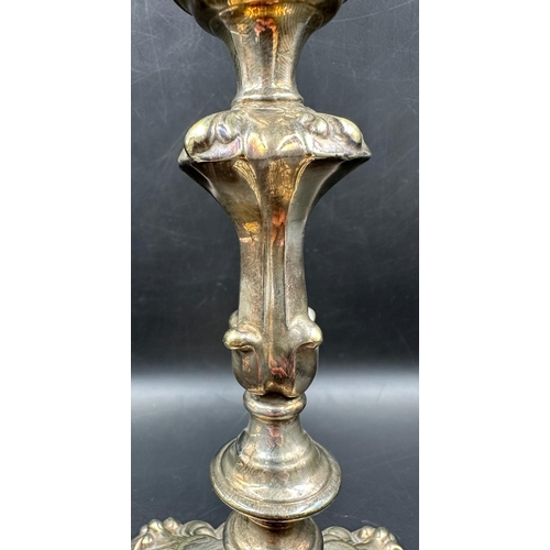 457 - A pair of ornate silverplated candlesticks.