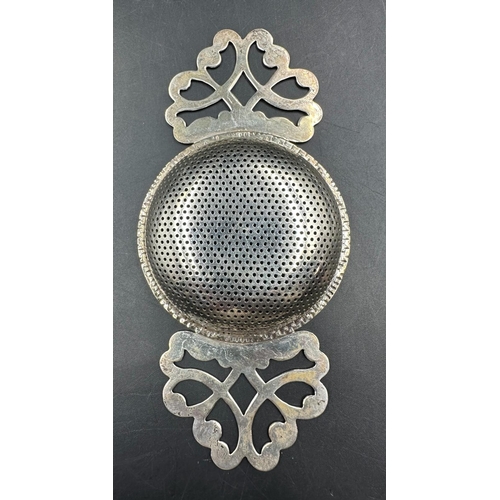 459 - A hallmarked silver tea strainer, Birmingham 1989 by R E Porter