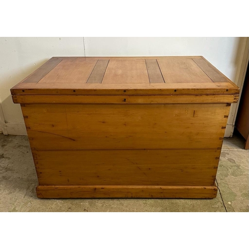 46 - A large pine panelled blanket box or chest with brass drop handles to side (H70cm W109cm D73cm)