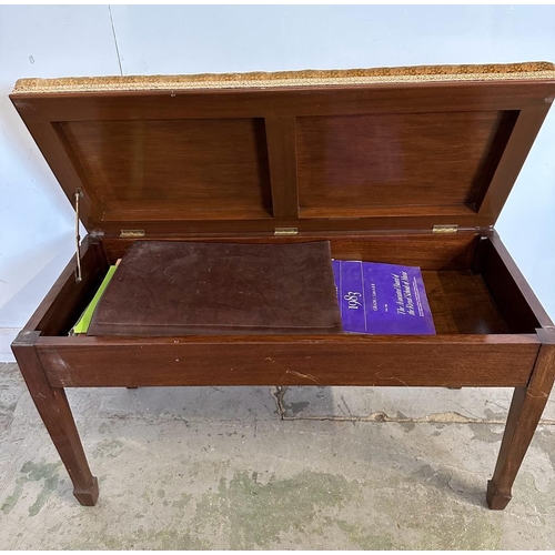 47 - A Mid Century mahogany flamed piano bench with hinged seat opening to storage (H51cm W90cm D38cm)