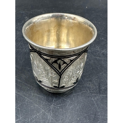 491 - A pair of silver Niello Vodka cups, marked 875 (Total weight 68.3g)