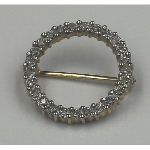 496 - A 9ct gold brooch with white stones and approximately 20mm in diameter and 1.6cm in weight