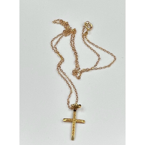 499 - A 9ct gold cross on a fine necklace with an approximate total weight of 2g.