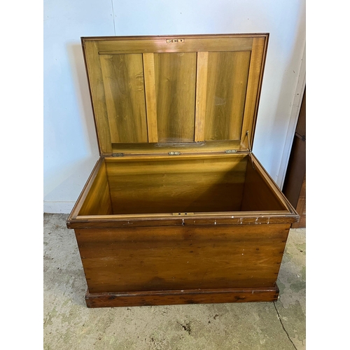 50 - A large pine panelled blanket box or chest with brass drop handles to sides (H70cm W109cm D73cm)