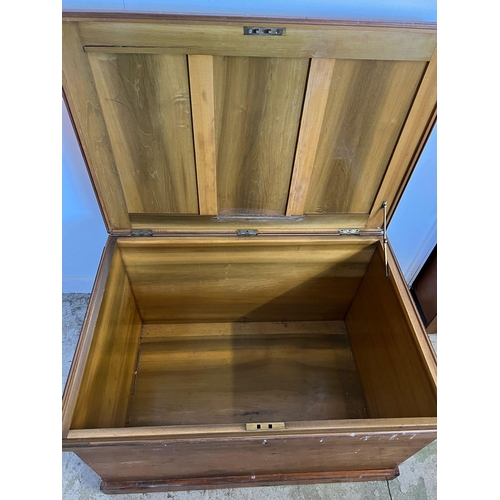 50 - A large pine panelled blanket box or chest with brass drop handles to sides (H70cm W109cm D73cm)